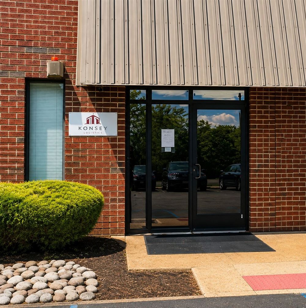 Entrance of the Konsey Logistics facility in Cinnaminson, New Jersey, with the Konsey Logistics sign beside the glass door